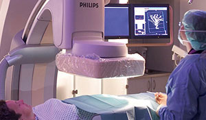Leger undersøker en pasient i en røntgenmaskin